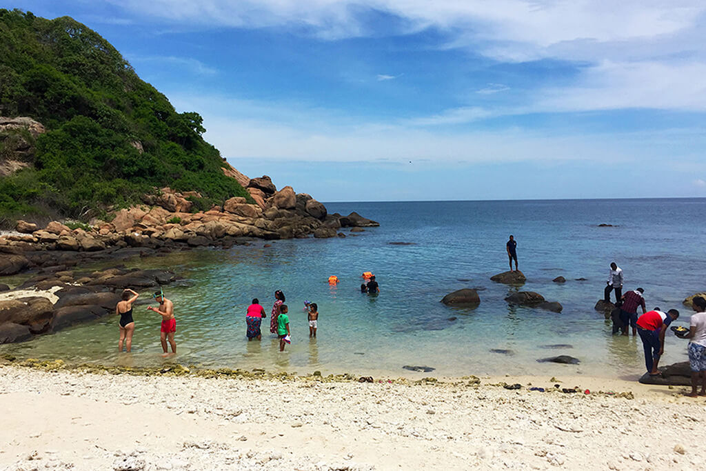 people preparing for snorkeling on the back side of pigeon island marine national park